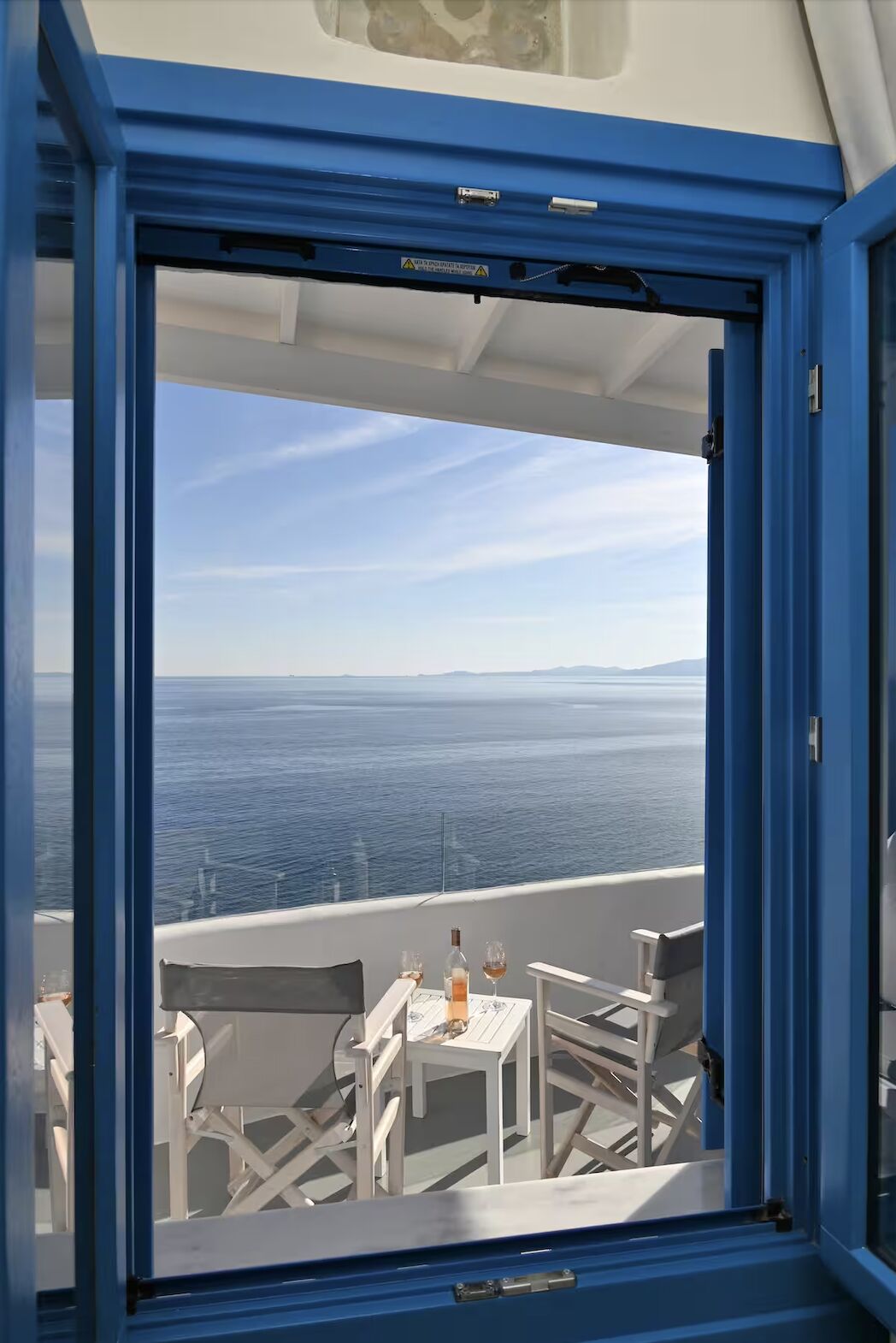 View through blue shutters to the Aegean Sea